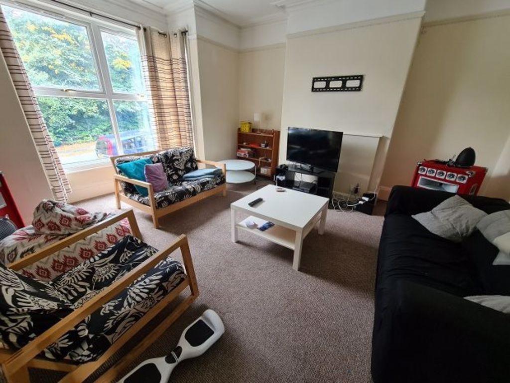 A contemporary and welcoming living room with a...