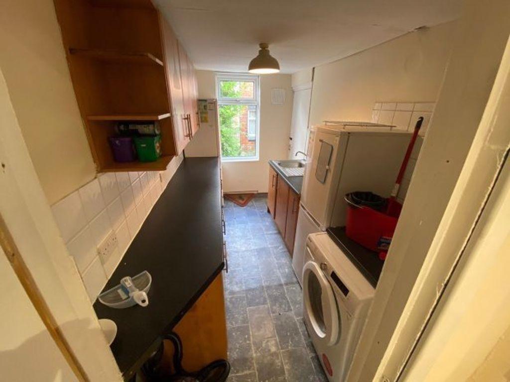 A compact kitchen area with a washing machine a...