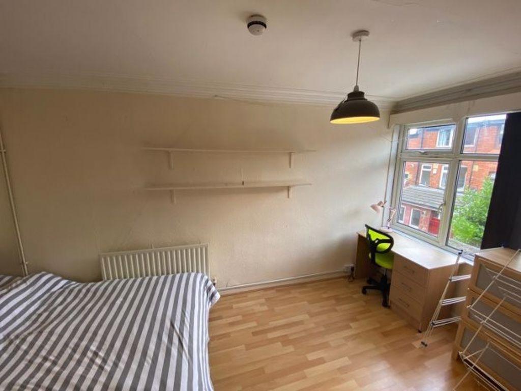 Bright and airy bedroom featuring a large windo...