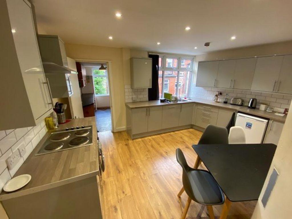 Modern and well-lit kitchen with ample workspac...