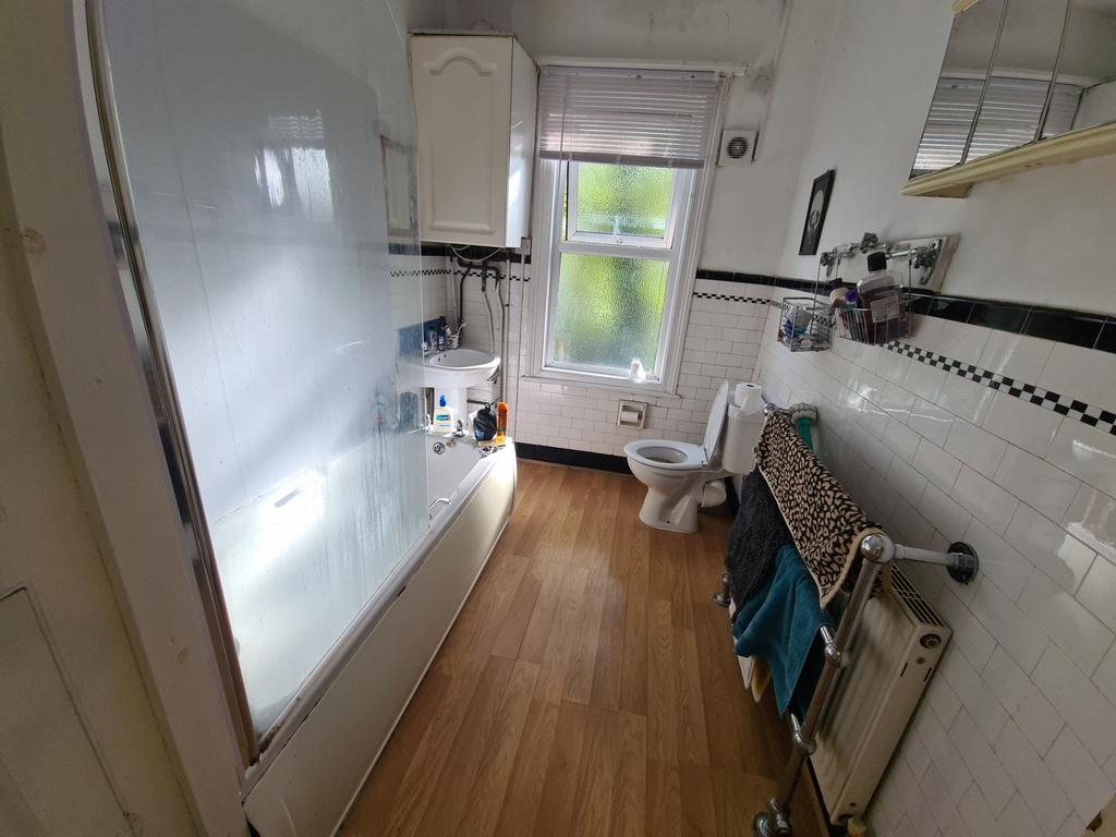 A clean and well-lit bathroom with basic amenit...
