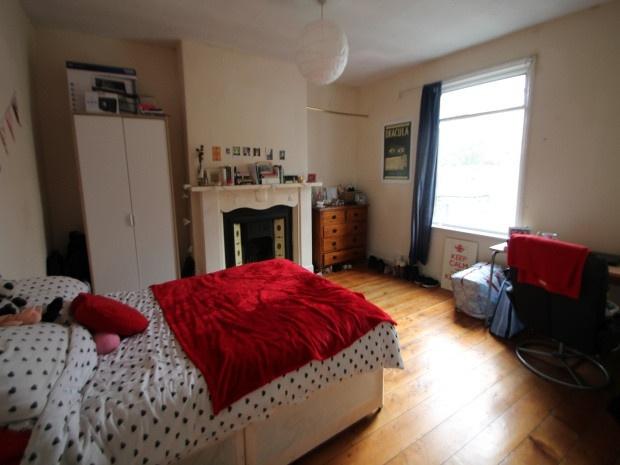 A bright and inviting bedroom featuring a doubl...