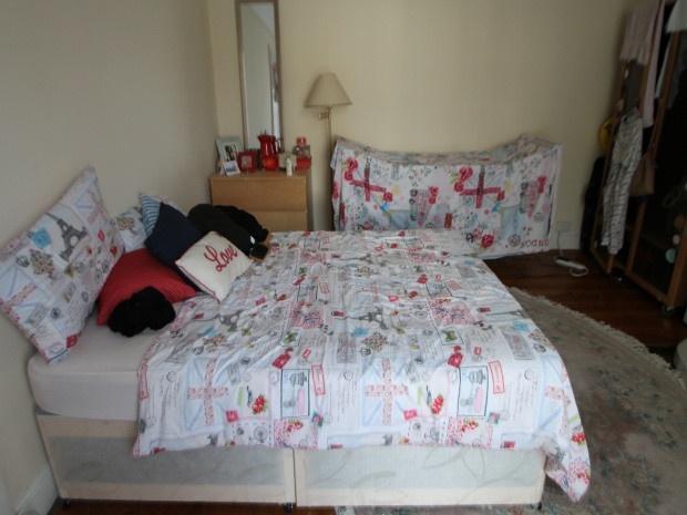 A spacious double bedroom featuring a comfortab...