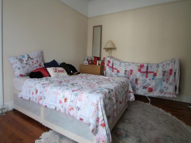 A bright and inviting double bedroom featuring ...