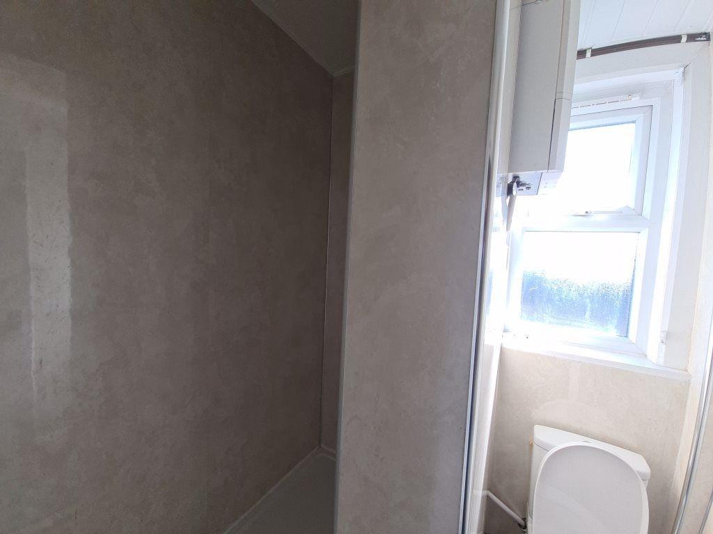 A bright and clean bathroom featuring a large w...