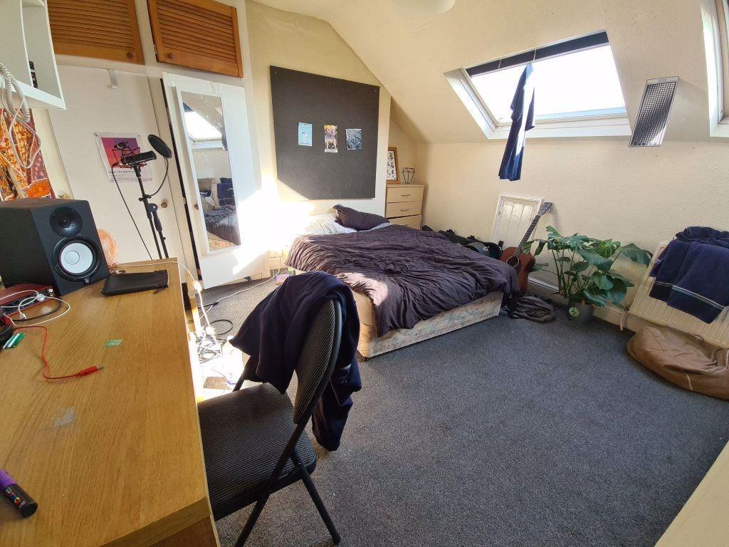 A bright and cozy bedroom with a neatly made be...