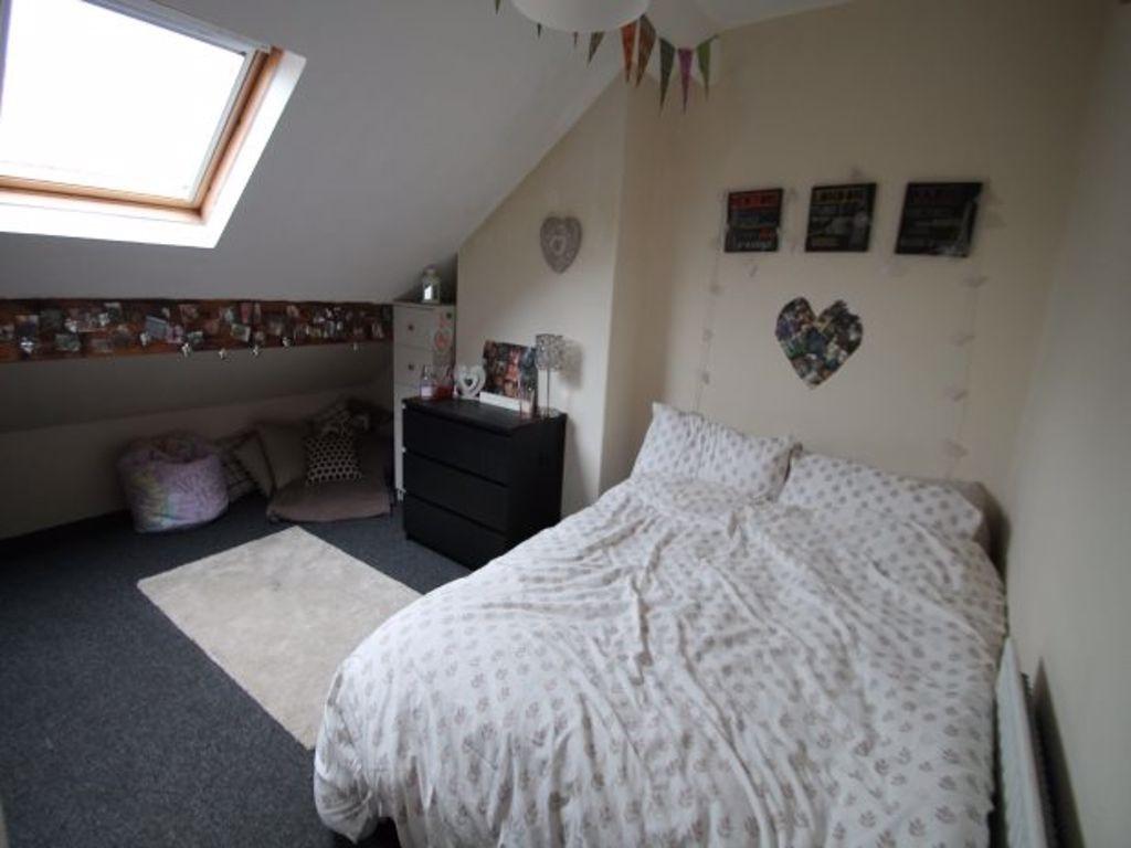 A spacious and bright master bedroom with a dou...