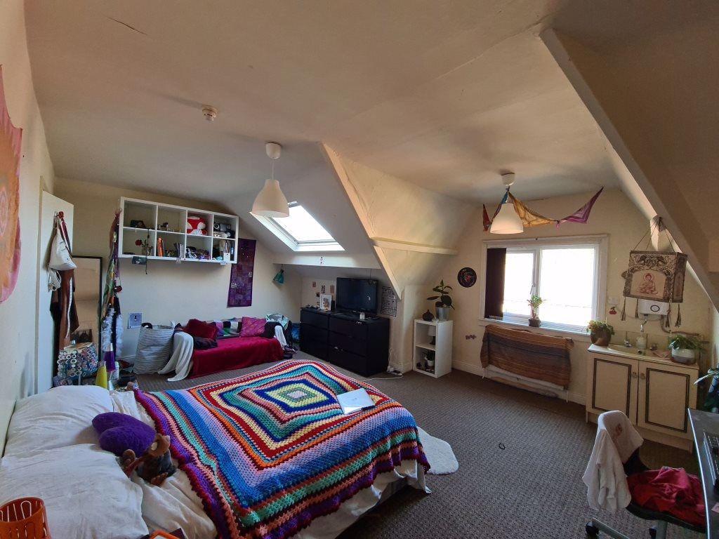 A cozy and well-maintained bedroom featuring a ...