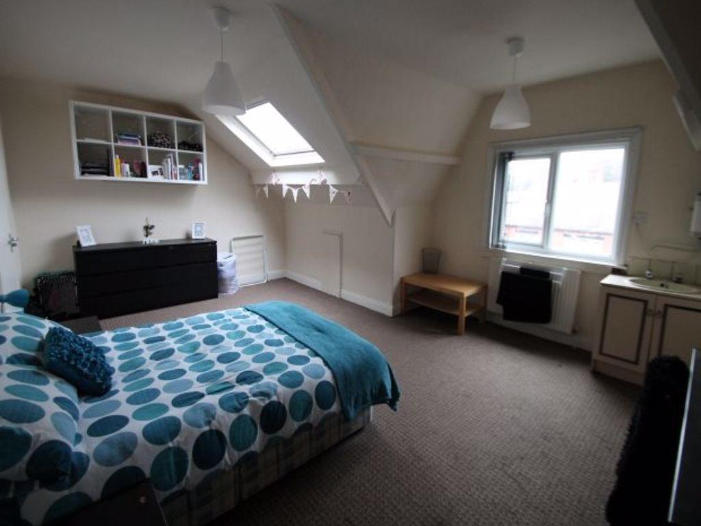 A spacious and bright master bedroom featuring ...