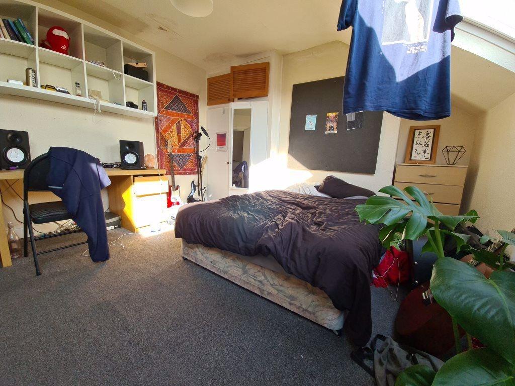 A spacious and well-lit master bedroom featurin...