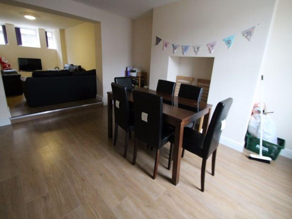 A spacious and bright living room featuring a m...