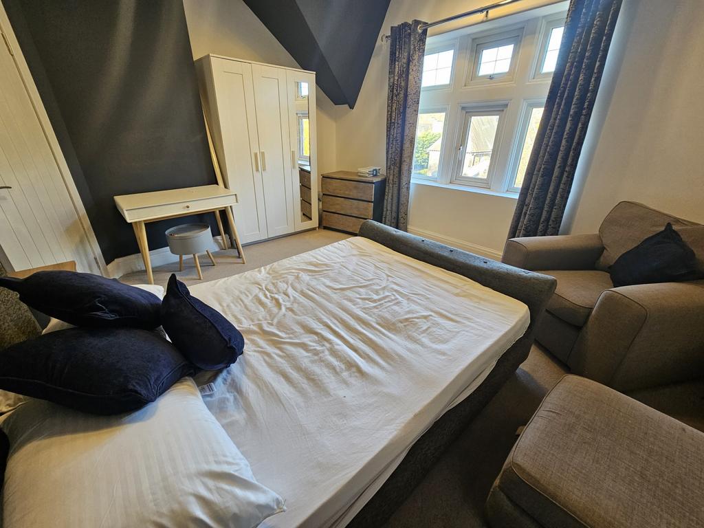 A spacious and inviting master bedroom featurin...