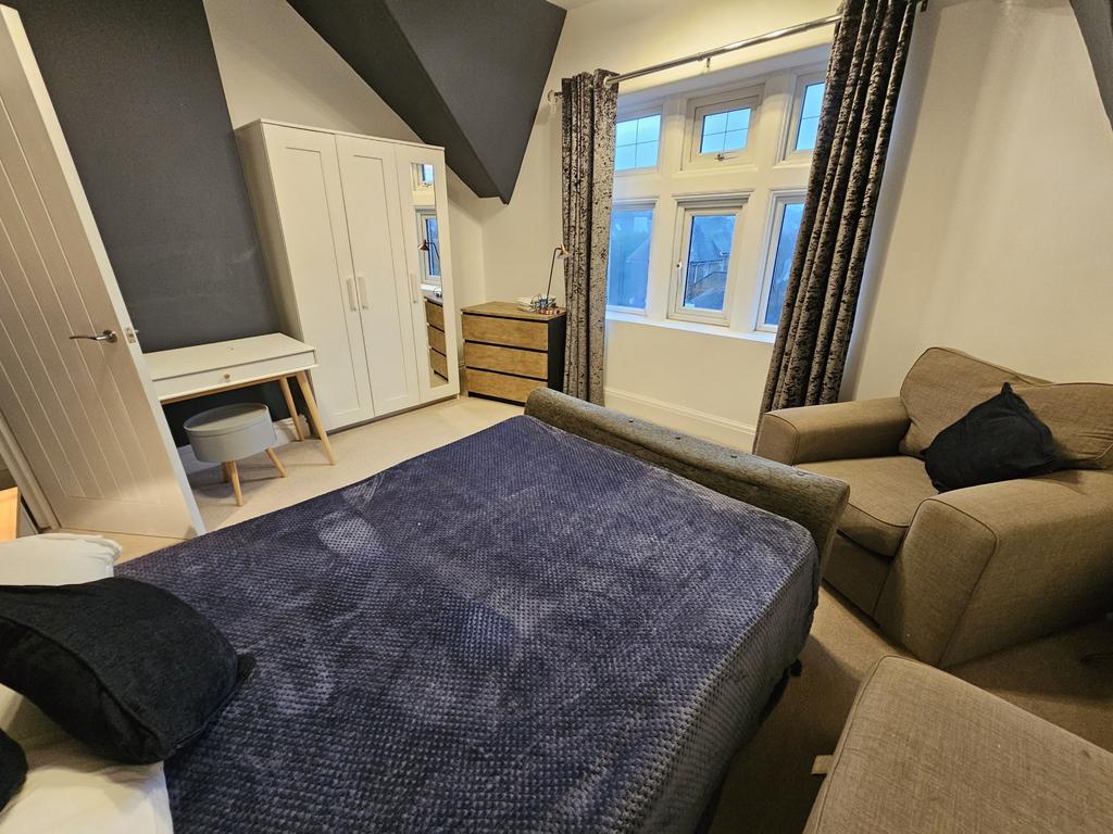 A cozy and well-maintained living room featurin...