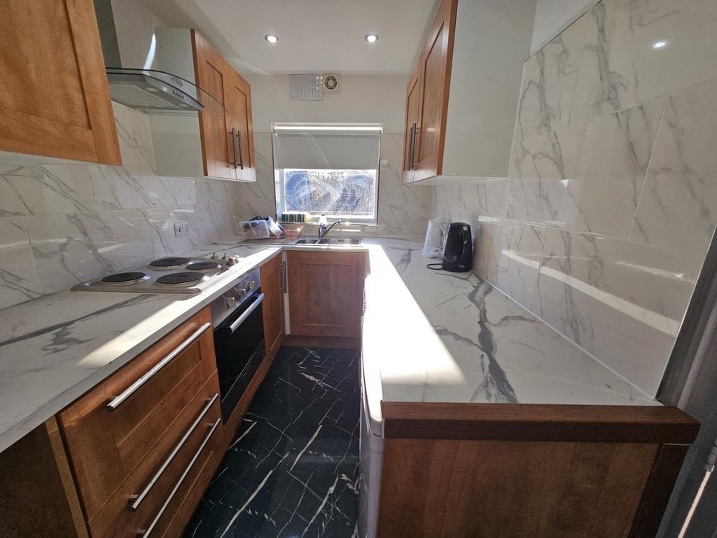 A modern, well-lit kitchen featuring sleek cabi...