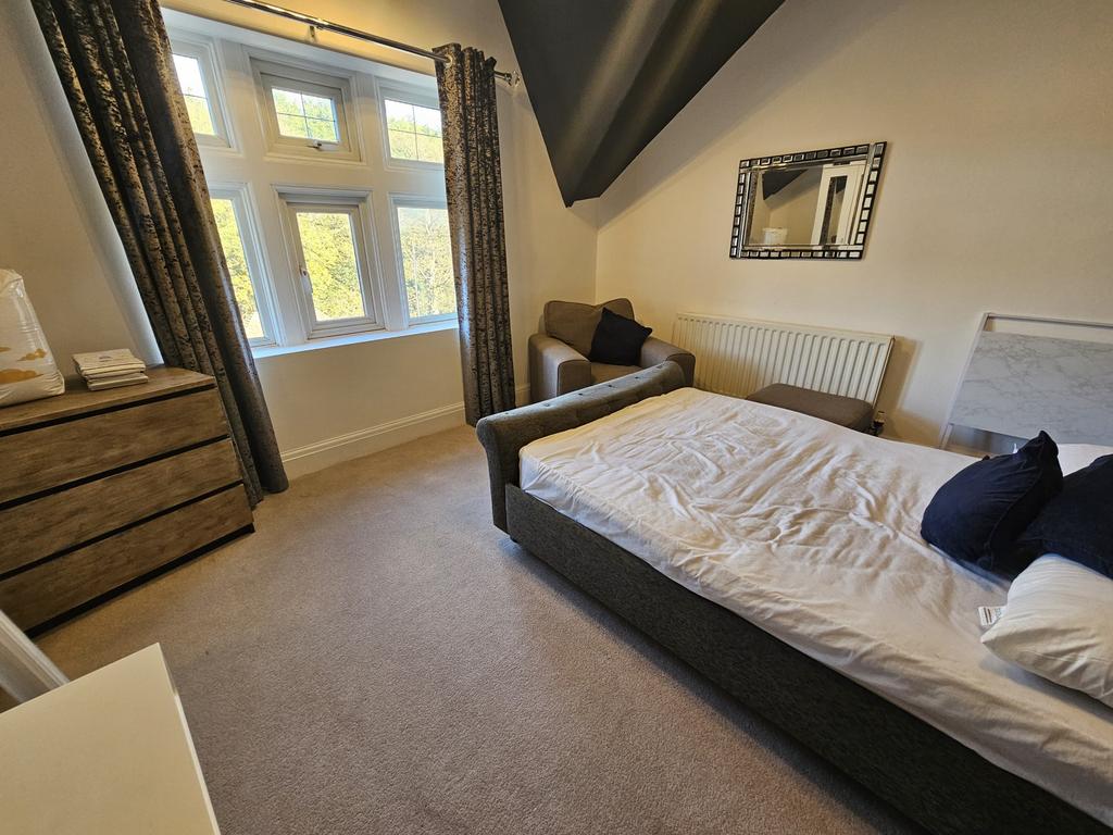 A well-maintained bedroom with ample natural li...