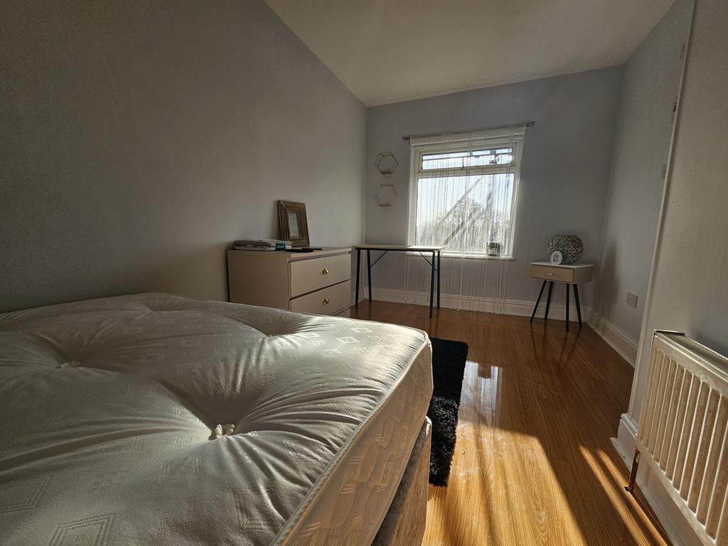 Bright and inviting bedroom featuring a large b...