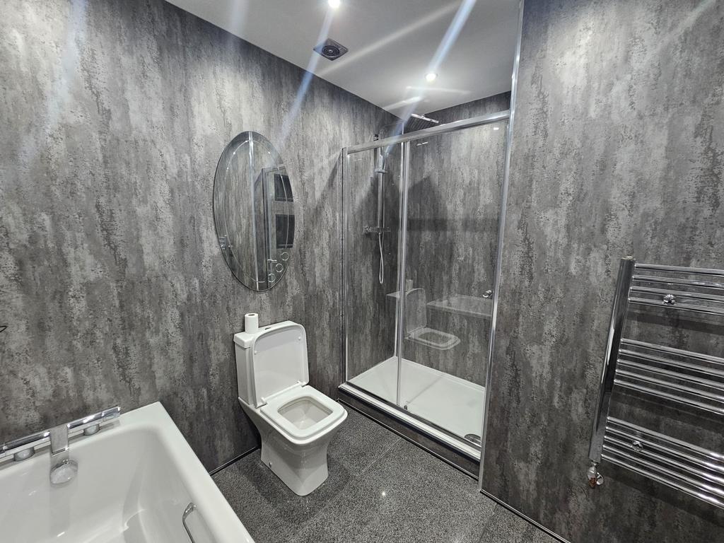 Modern bathroom featuring a walk-in shower with...