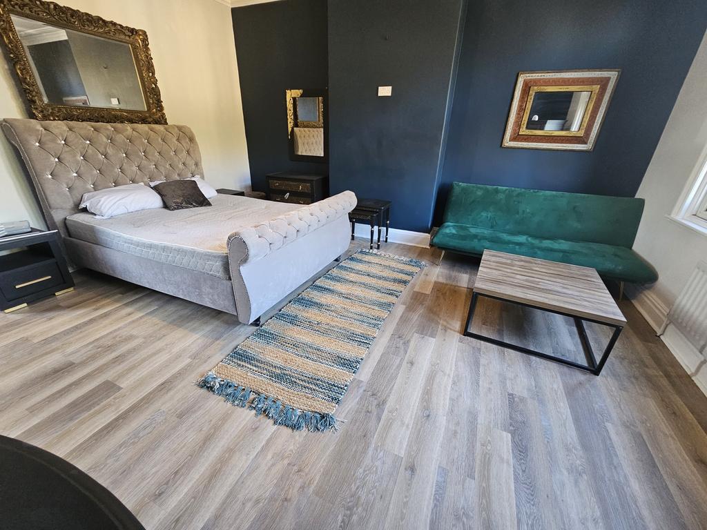 A spacious, beautifully furnished master bedroo...