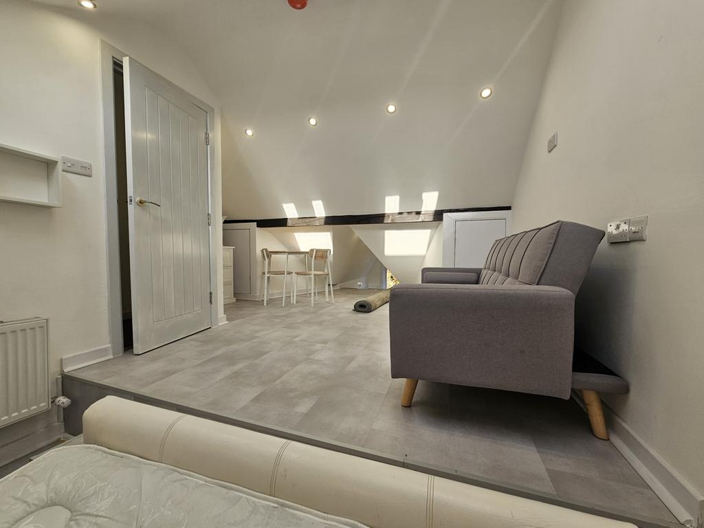 A spacious and modern living room featuring com...