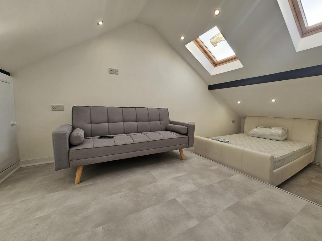A bright and modern living room featuring a gre...