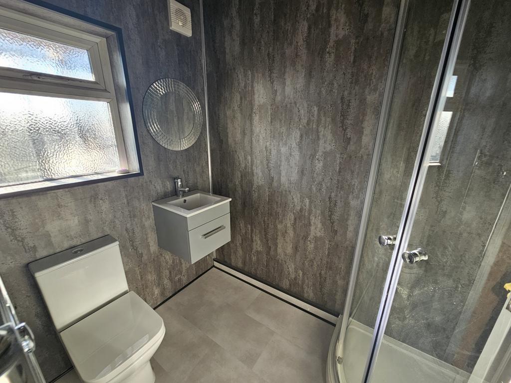 A spacious and modern bathroom featuring a larg...