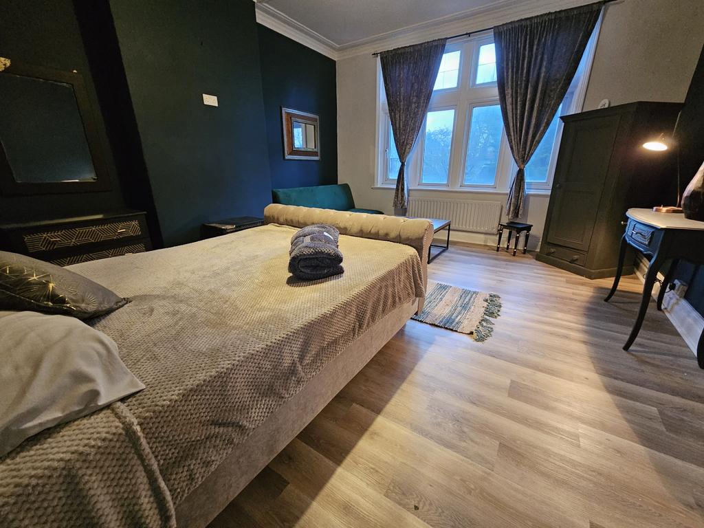 A spacious, well-lit living room with large win...