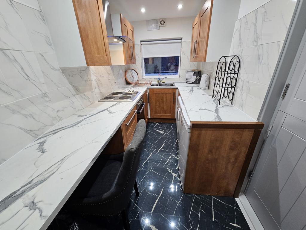 Bright and modern kitchen with sleek white marb...