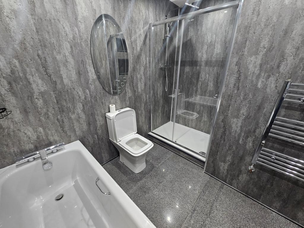 Modern and clean bathroom with a spacious showe...