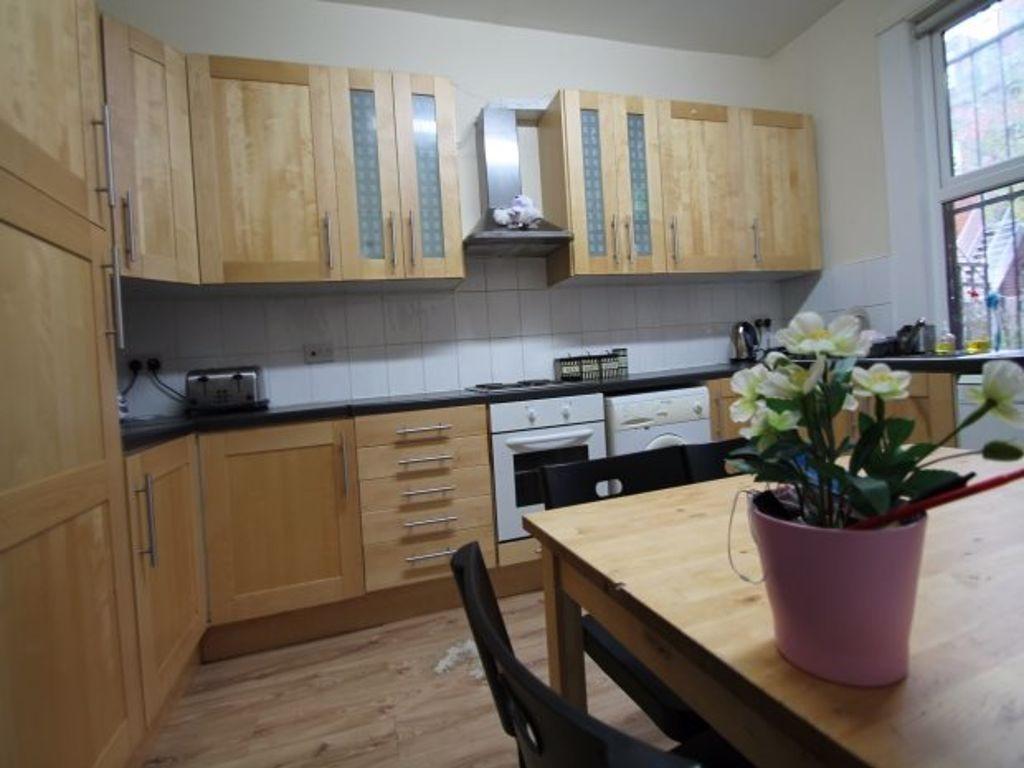 A well-maintained kitchen featuring wooden cabi...