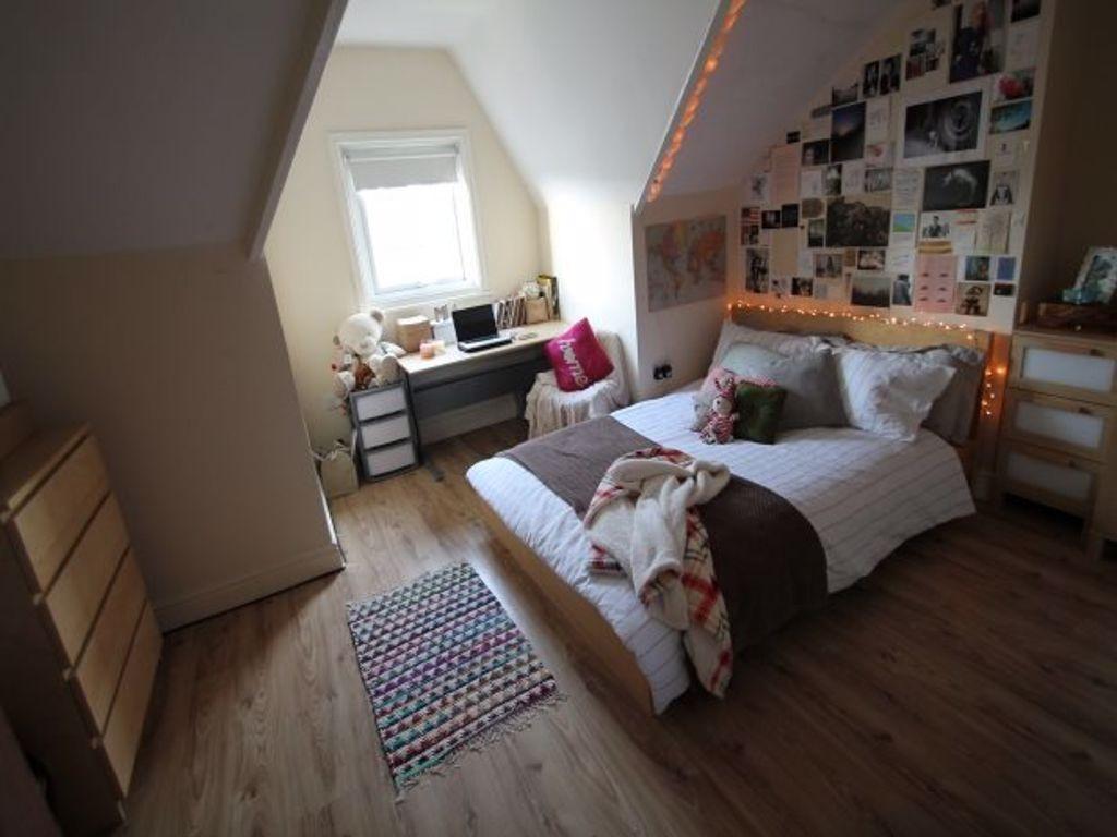 A bright and cozy bedroom featuring a double be...
