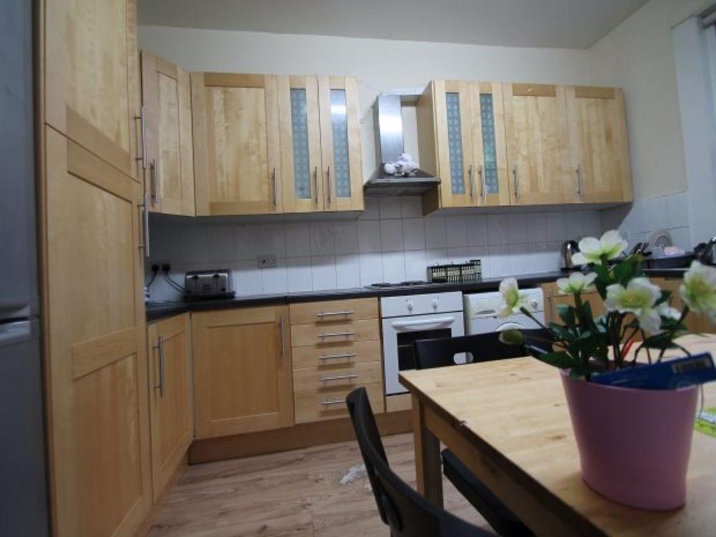 A well-maintained kitchen with ample storage ca...
