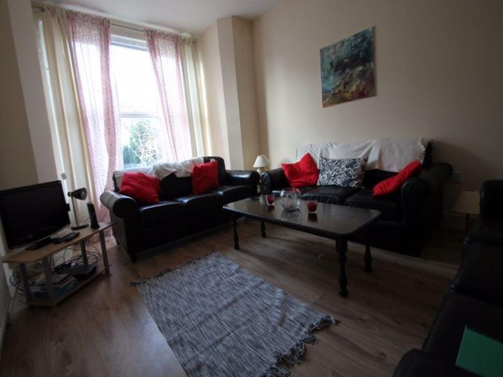 A spacious and well-lit living room featuring c...