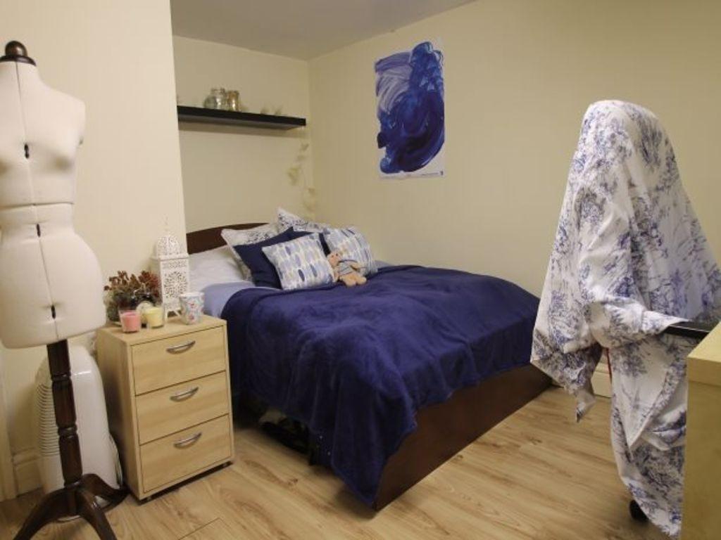 A cozy and well-maintained bedroom featuring a ...