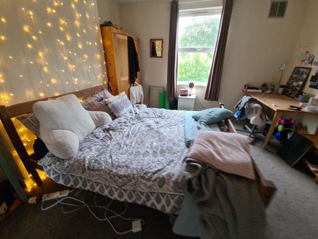 A spacious and inviting double bedroom featurin...