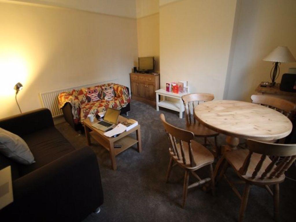 A cozy, well-maintained living room featuring a...