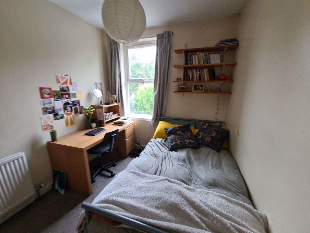 A cozy and neatly arranged bedroom with a comfo...