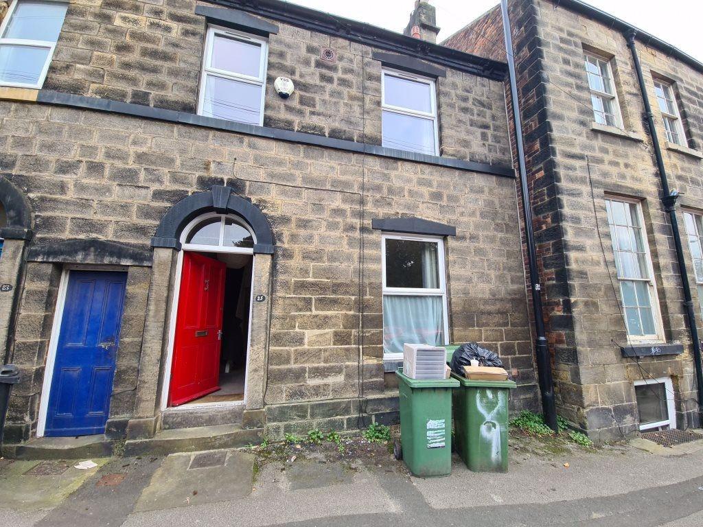 A charming stone-fronted house with a vibrant r...