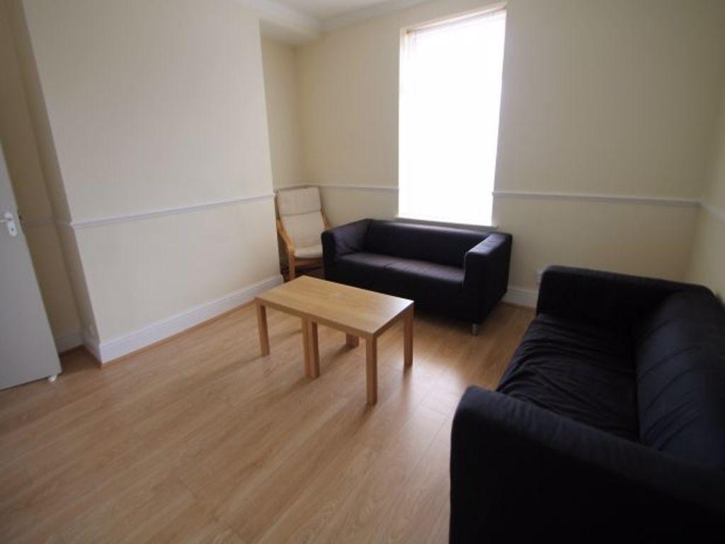 A well-lit, tidy living room featuring two comf...