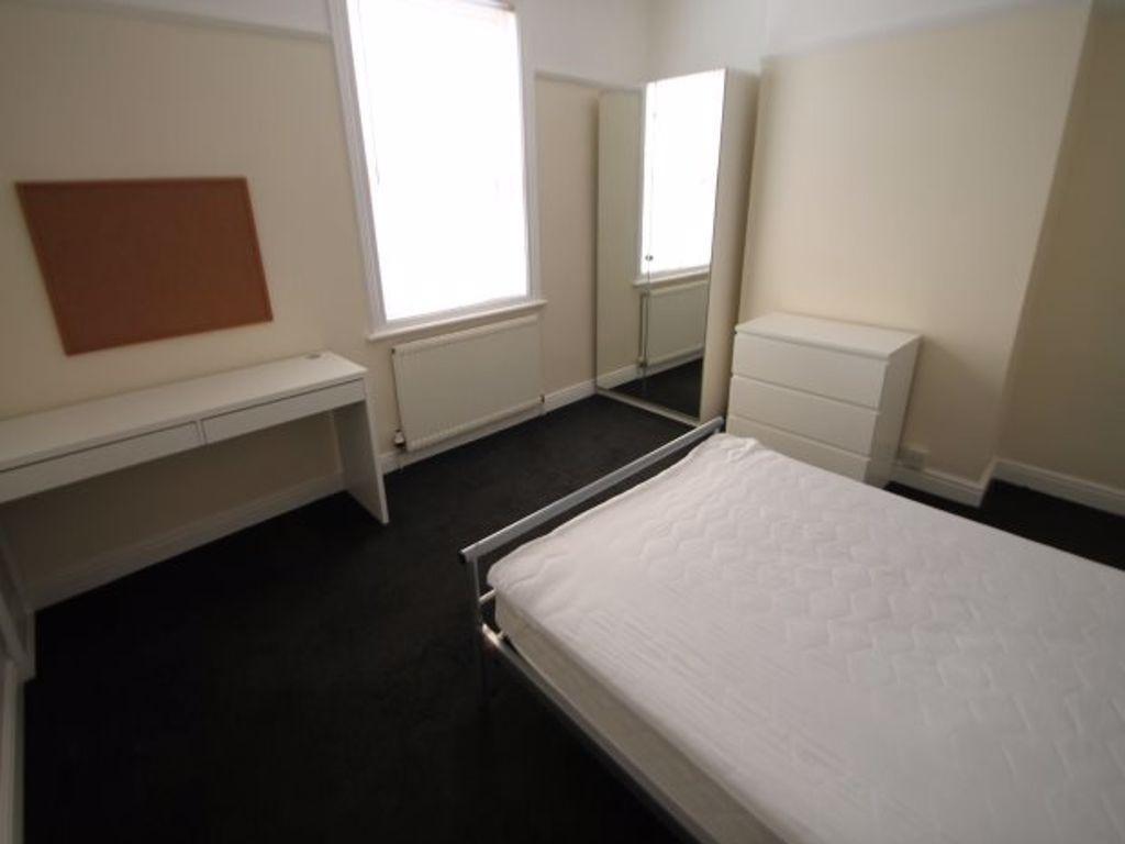 A neatly presented bedroom with a comfortable b...