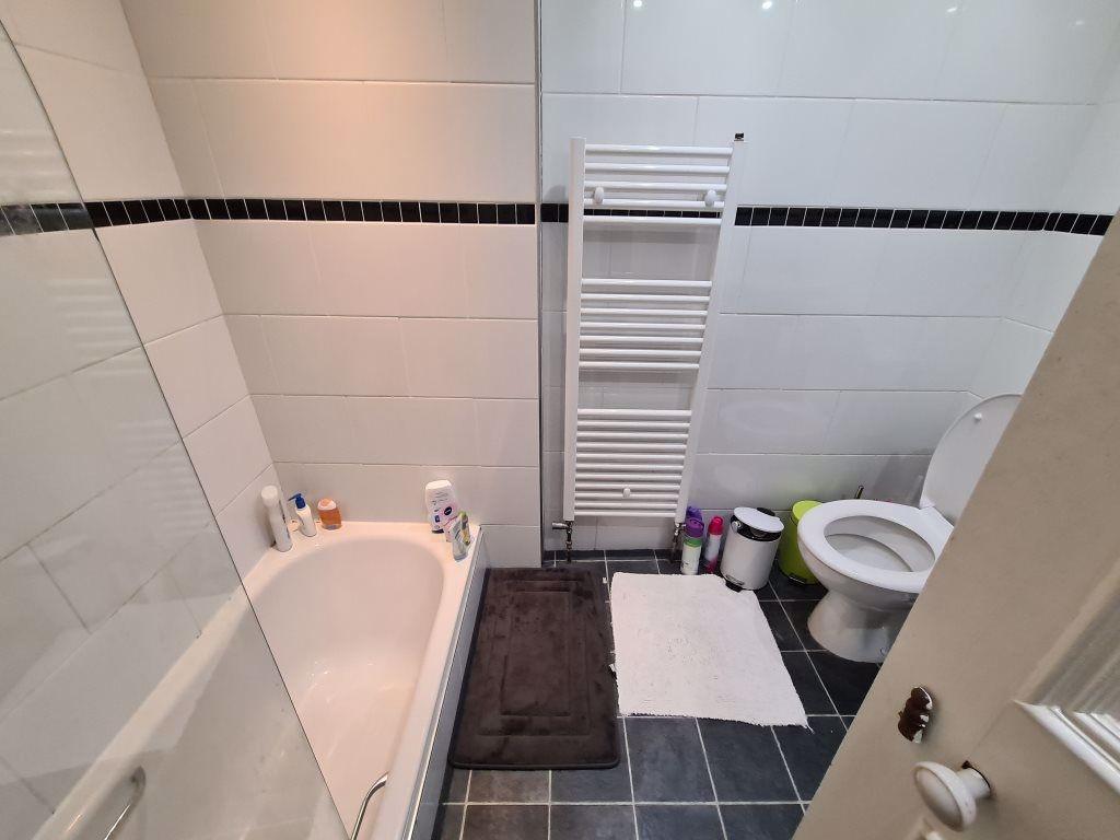A well-maintained bathroom with a spacious bath...