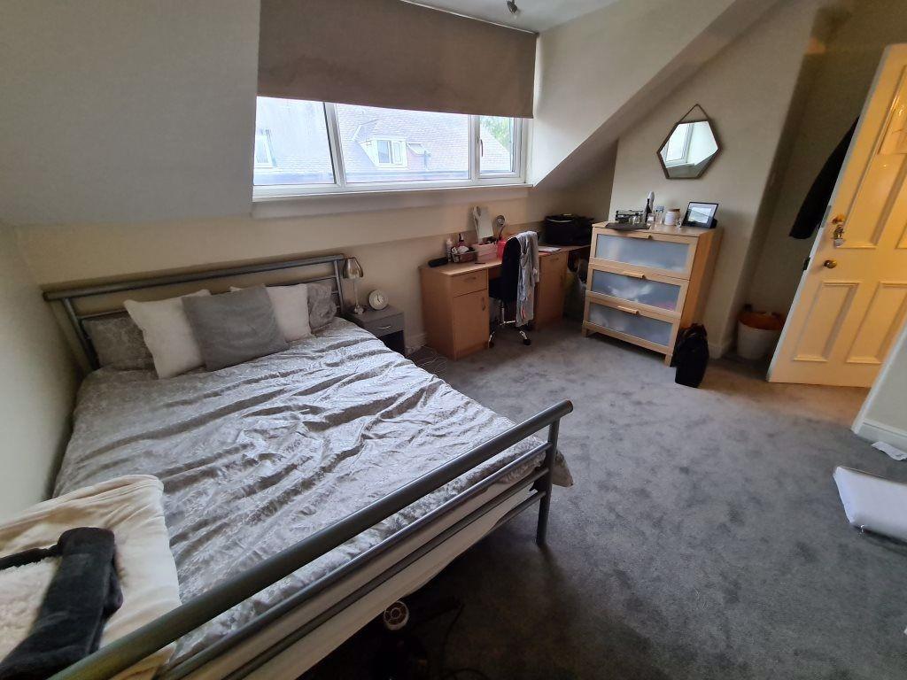 A cozy bedroom with a comfortable bed, ample na...
