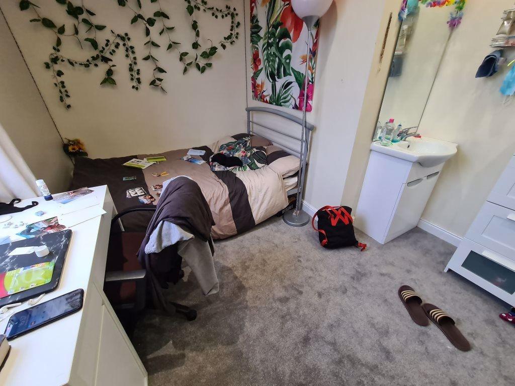 A cozy single bedroom featuring a bed and perso...