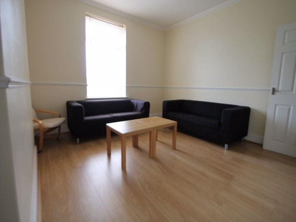 A bright and welcoming living room featuring tw...