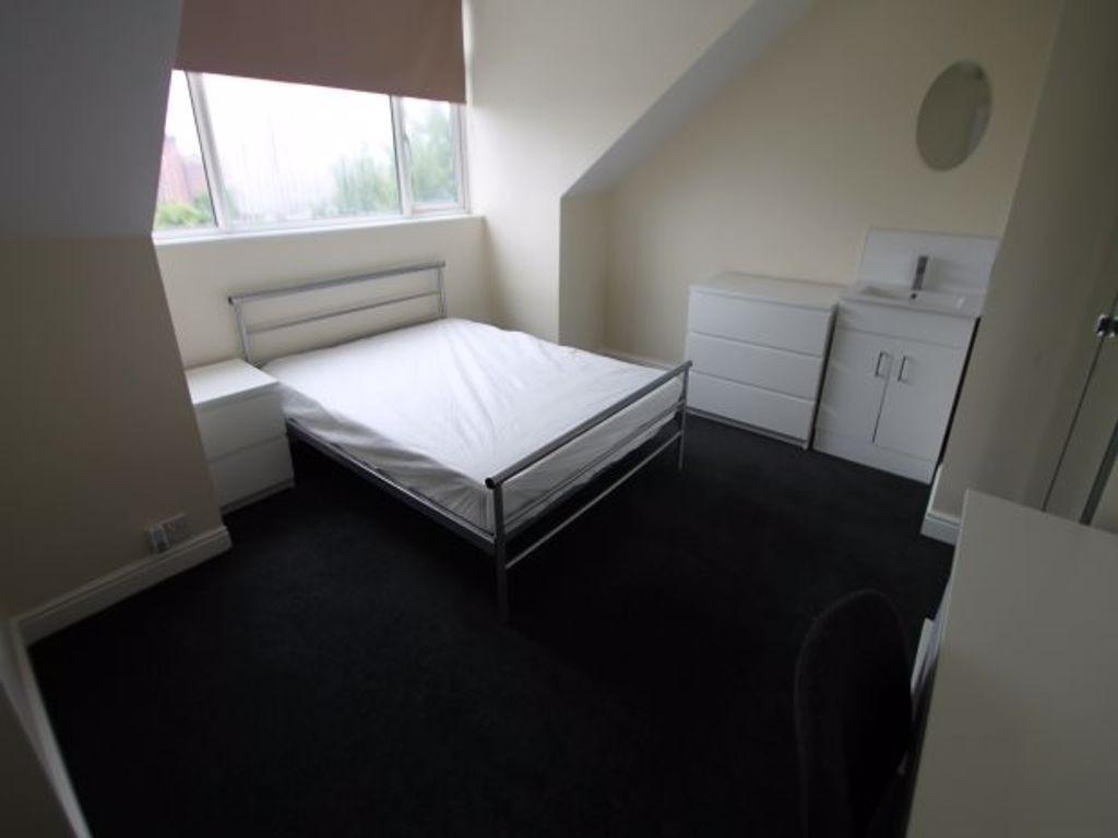 A tidy bedroom featuring a double bed, with a l...