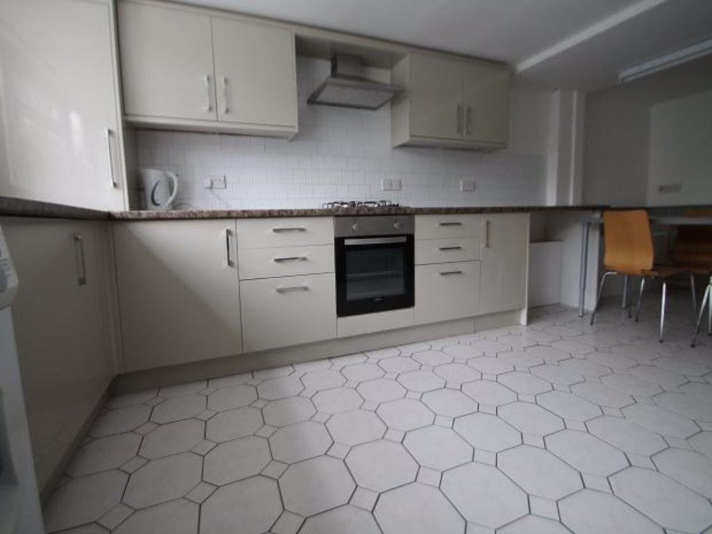 A modern, clean kitchen with ample storage cabi...