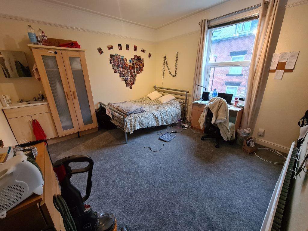 A cozy and well-lit bedroom featuring a single ...