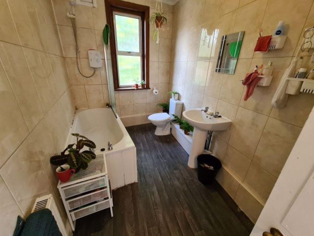 Bright and well-maintained bathroom featuring a...