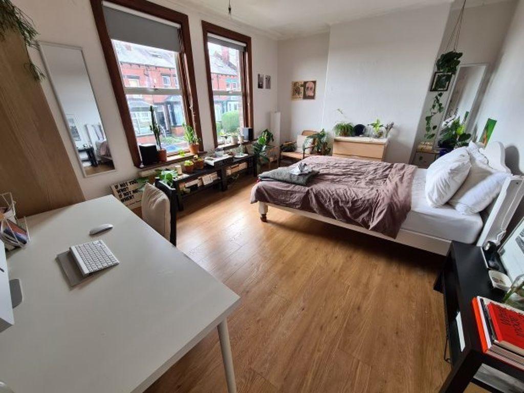 A bright and spacious living room with large wi...