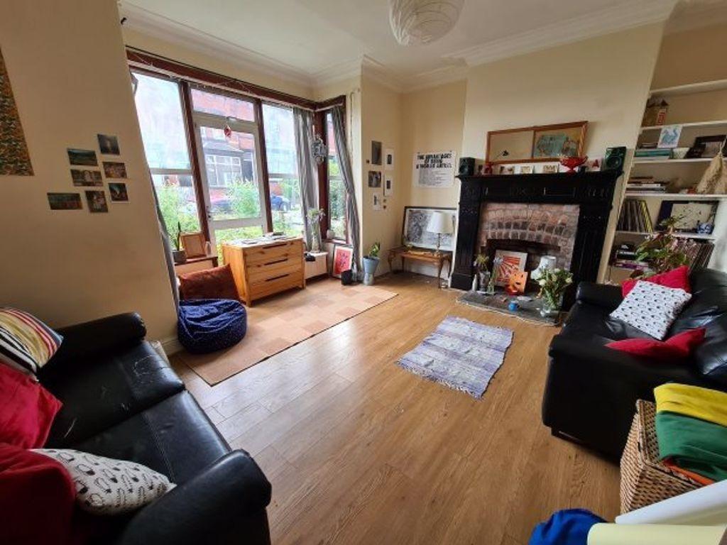 A spacious and well-lit living room featuring c...
