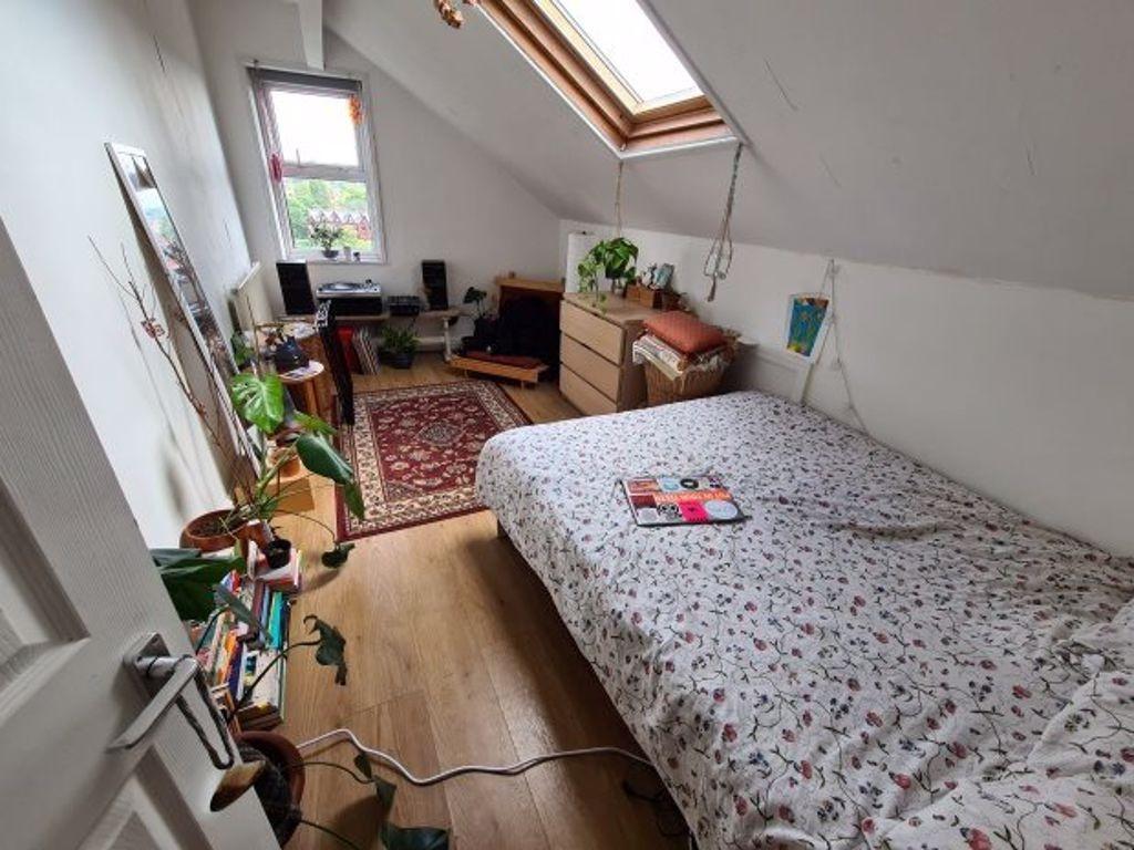 A cozy and well-maintained bedroom featuring a ...